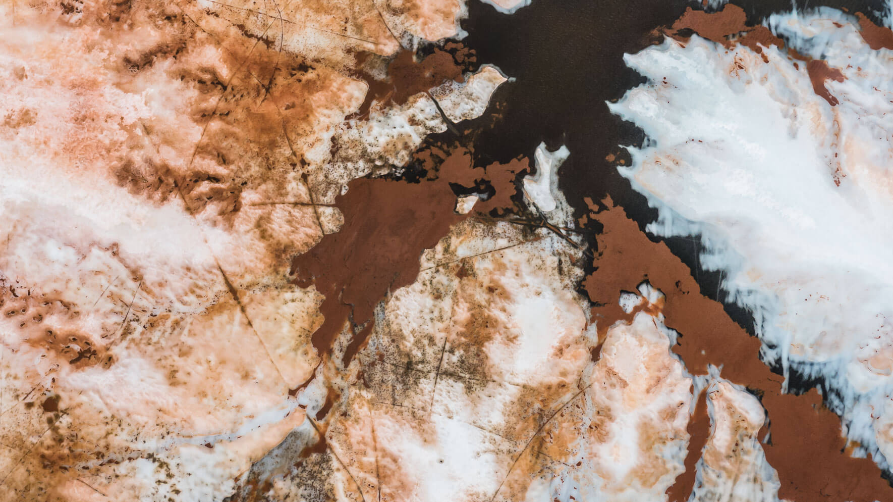 Abstract patterns on a frozen lake in Norway from a drone's perspective