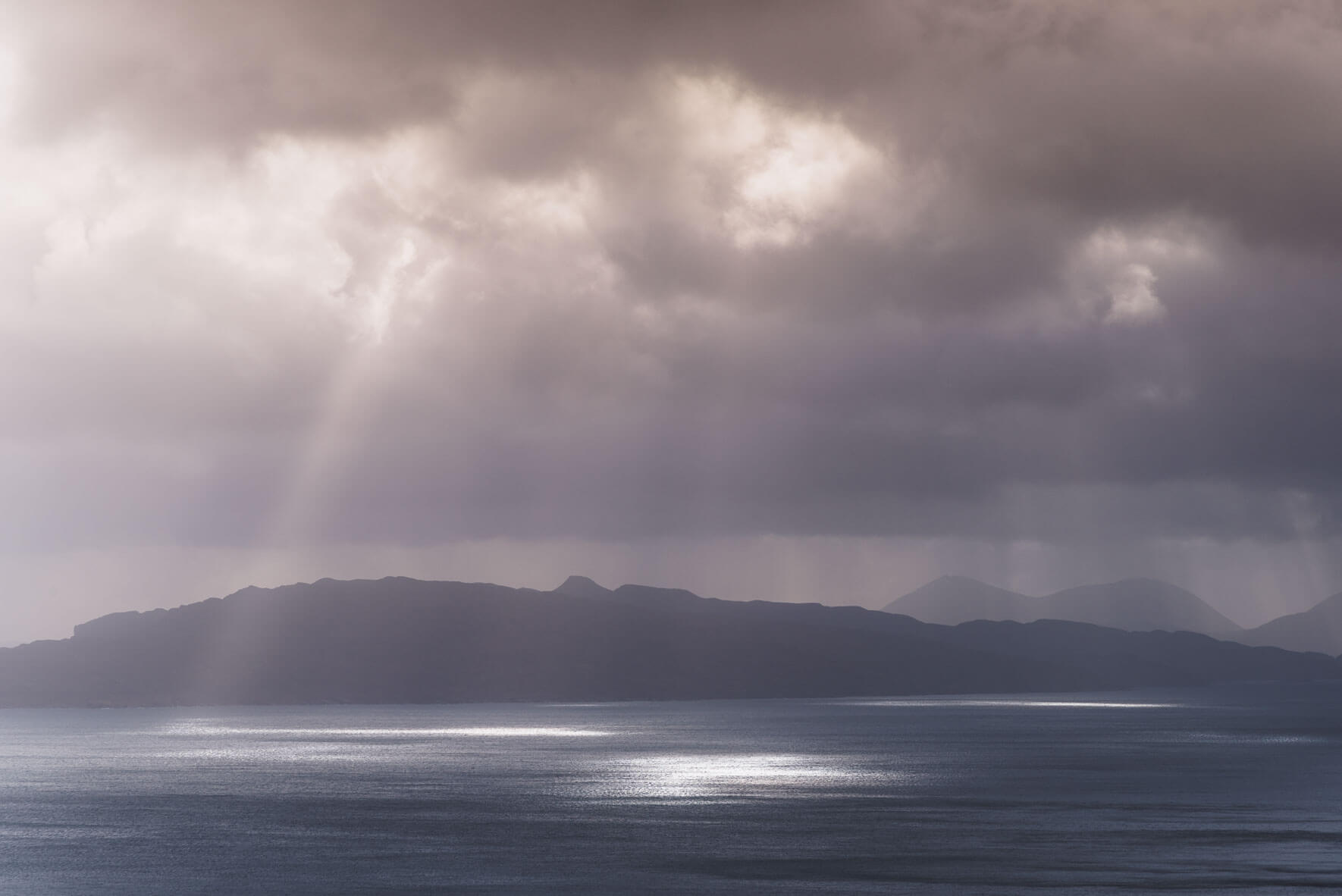 Sun breaks through the clouds over the Isle of Skye in Scotland