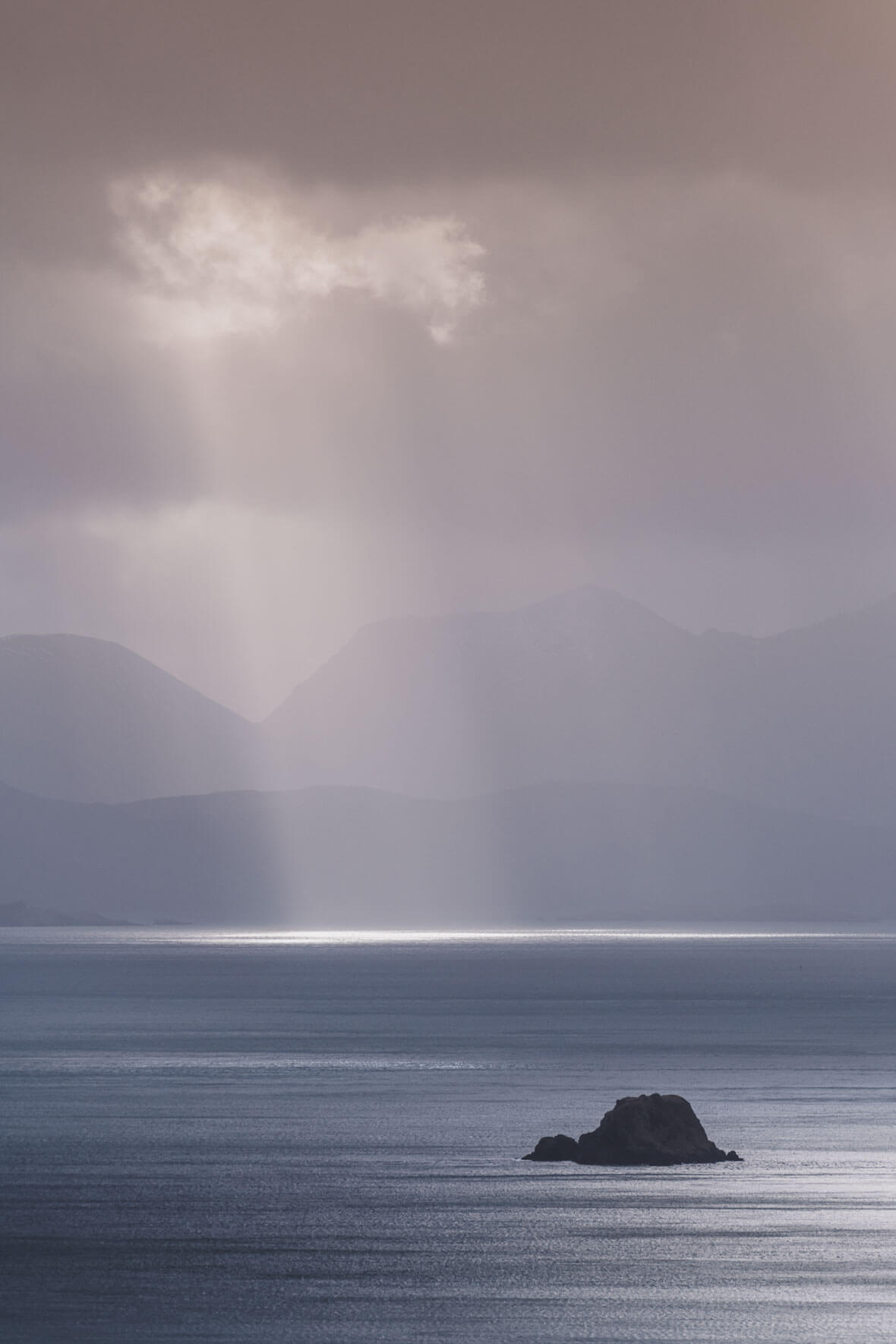 Sun breaks through the clouds over the ocean