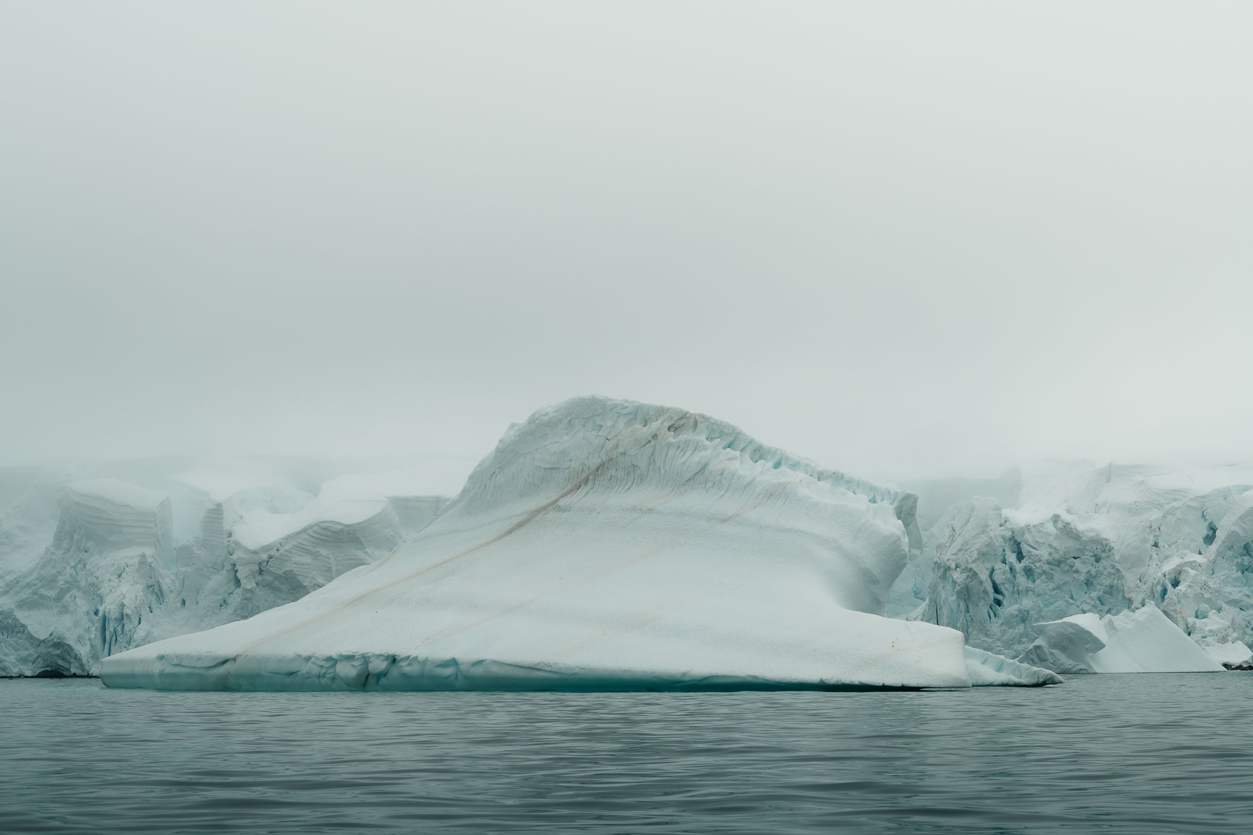 Abstract iceberg in foggy weather of Antarctica