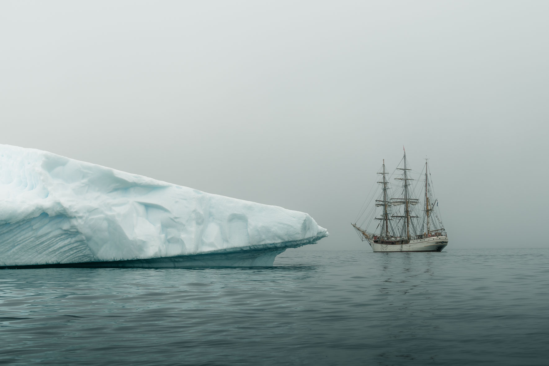 The tall ship Bark Europa with iceberg in Antarctica