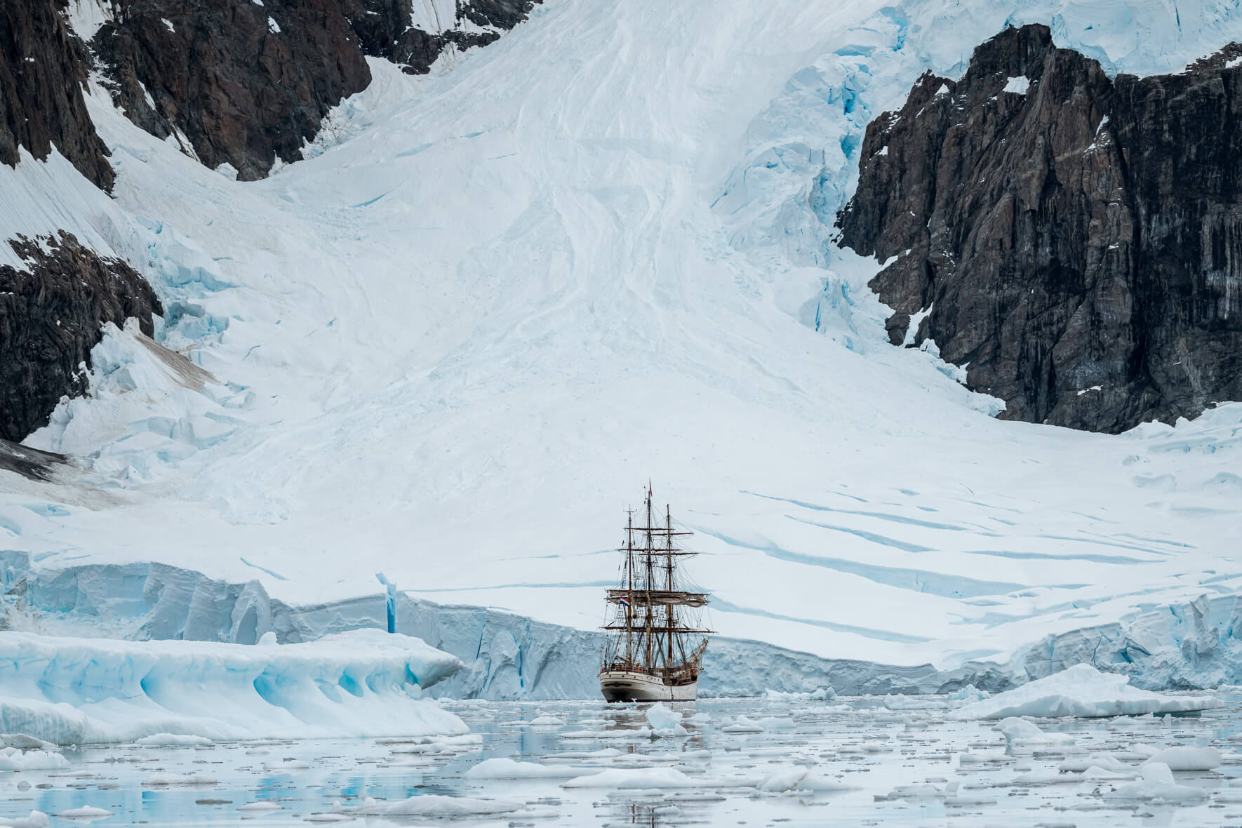 Tall ship Bark Europa and glacier landscape