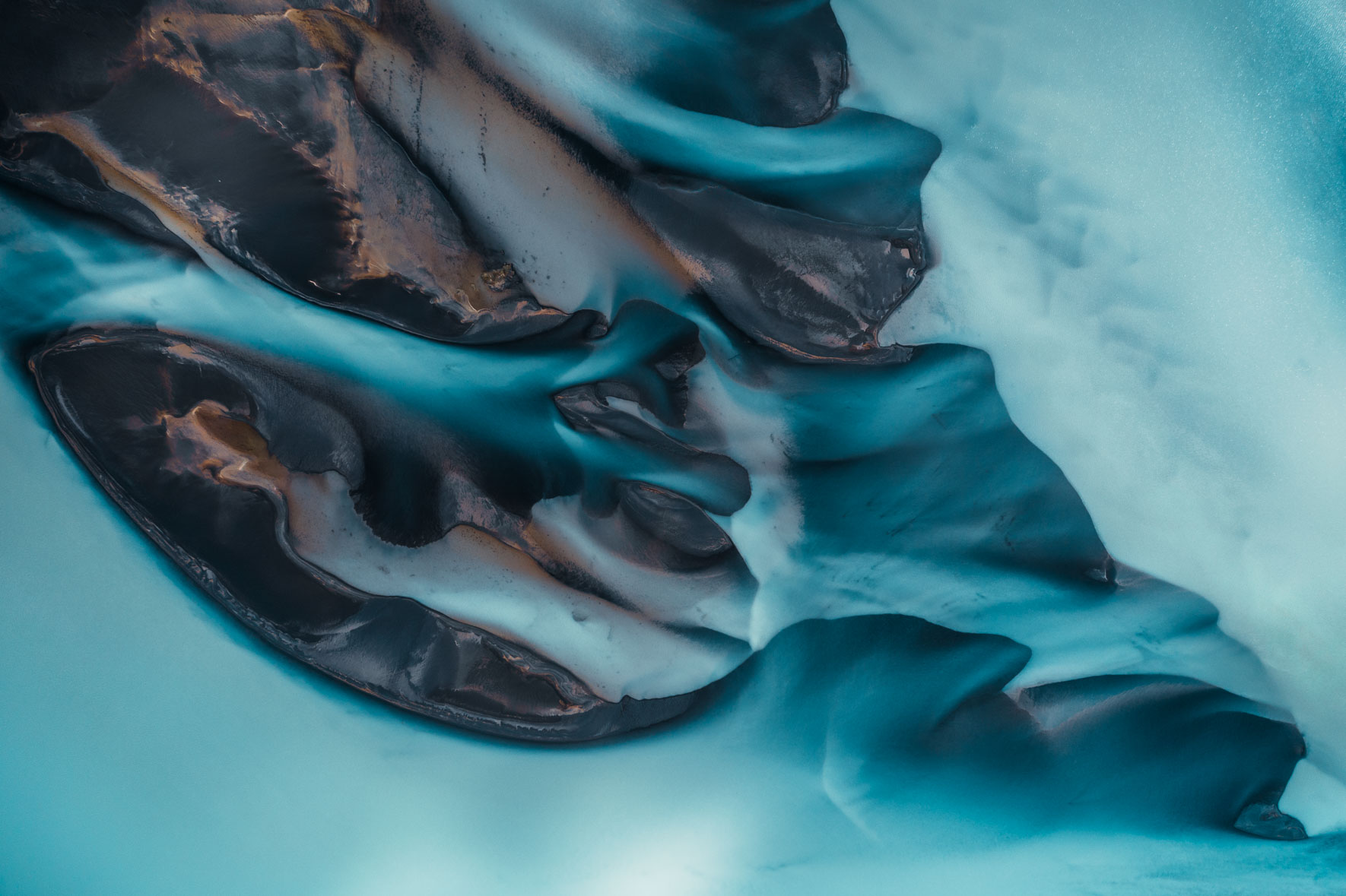 Aerial photography of glacier river in Iceland in blue colors