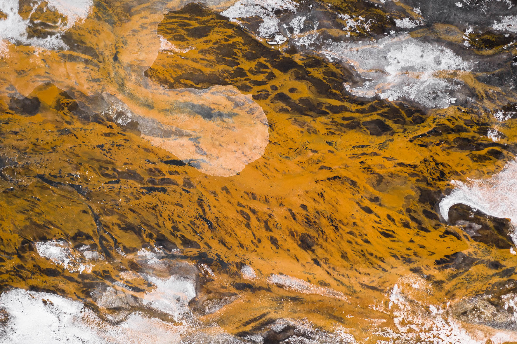 Aerial Landscape of Iceland with Black Sand, Orange River and Snow