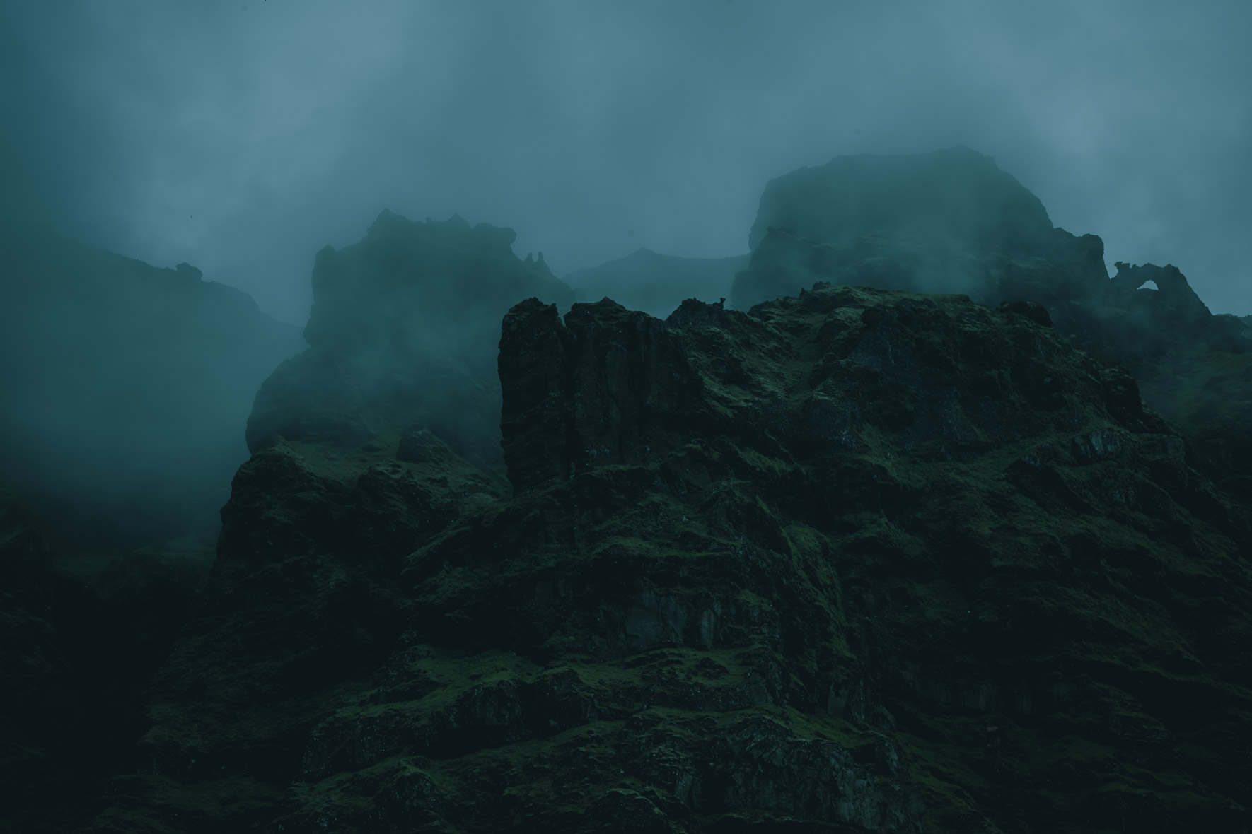 Dark and Moody Mountain Landscape with Low Clouds