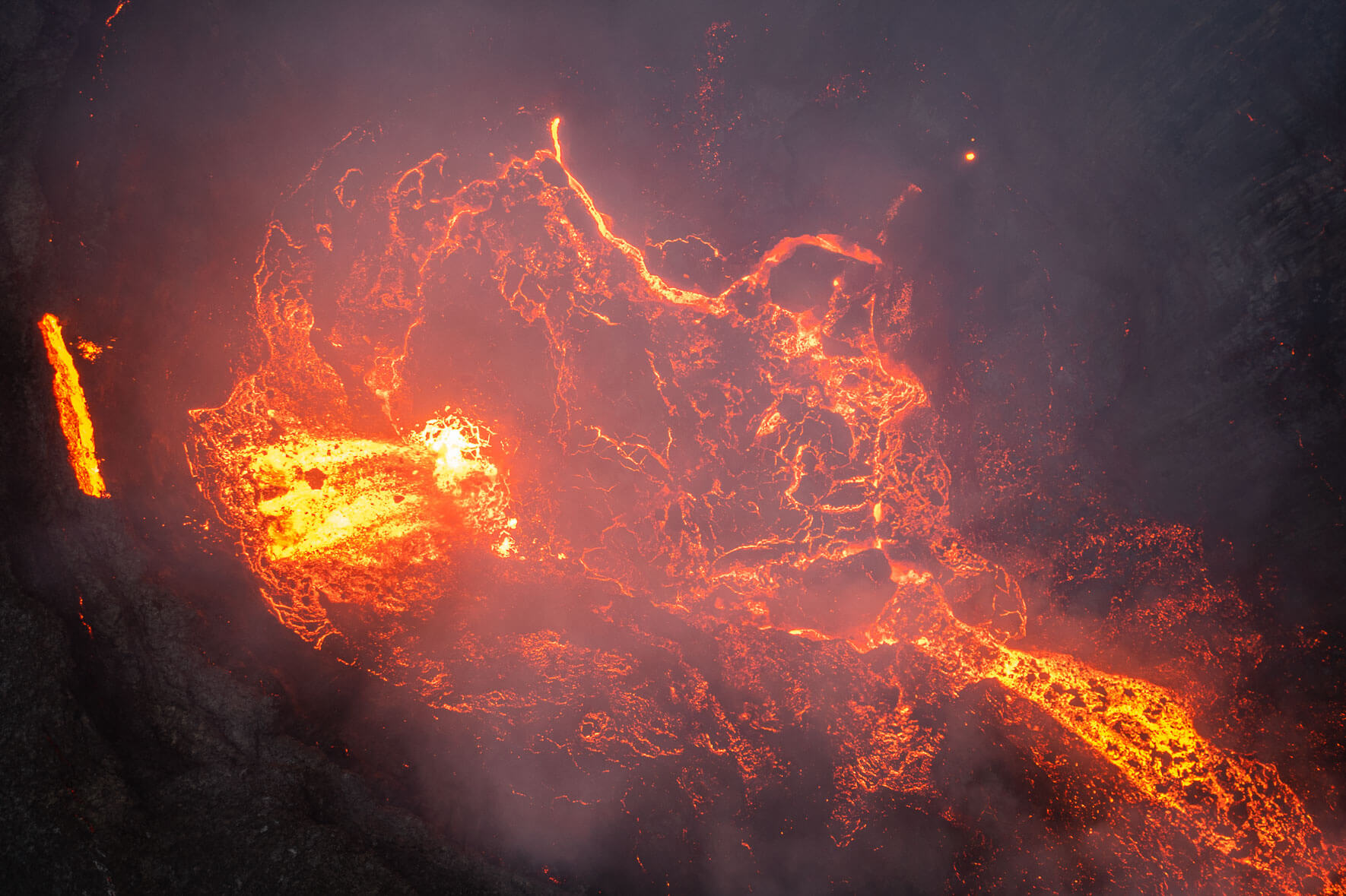 Aerial view of the crater of the Fagradalsfjall volcano in Iceland with flowing lava