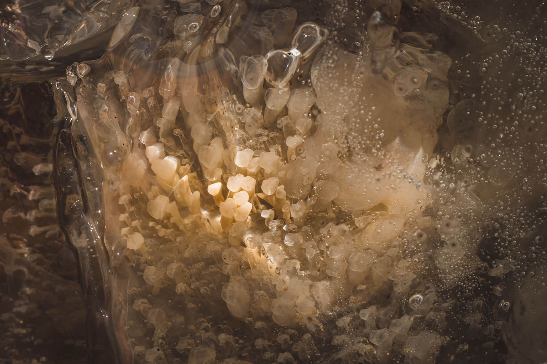 Abstract macro photography of glacial ice of Vatnajökull glacier in Iceland with air pockets and sediments