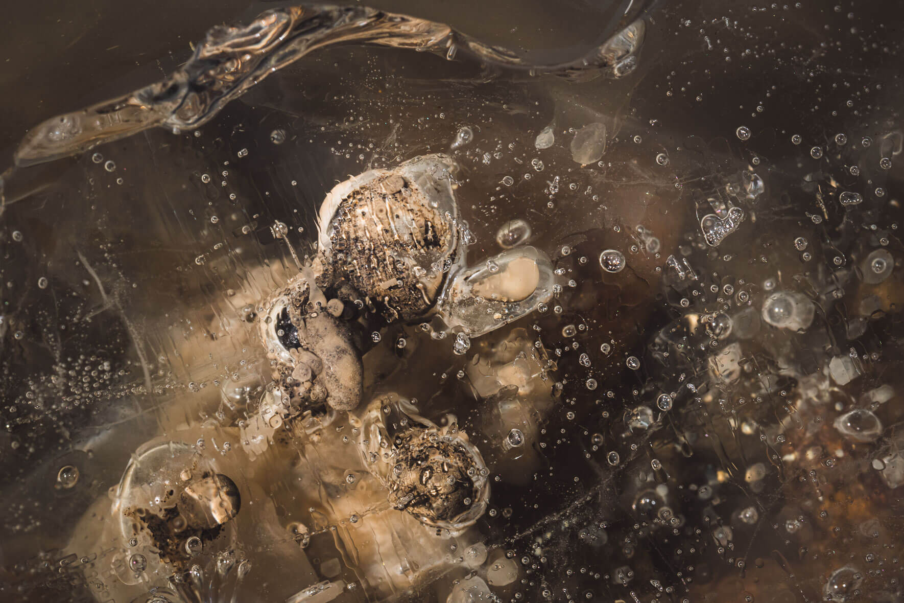 Abstract macro photography of glacial ice of Vatnajökull glacier in Iceland with air inclusions and sediments