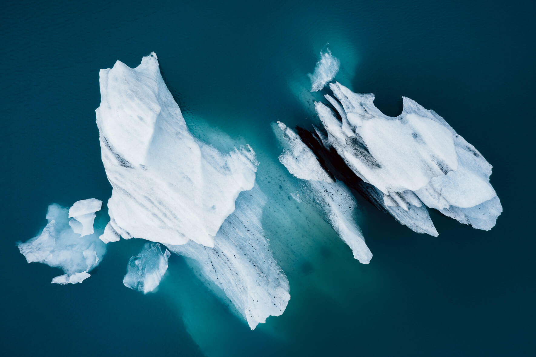 Aerial photography of icebergs in turquoise glacier lagoon in Iceland