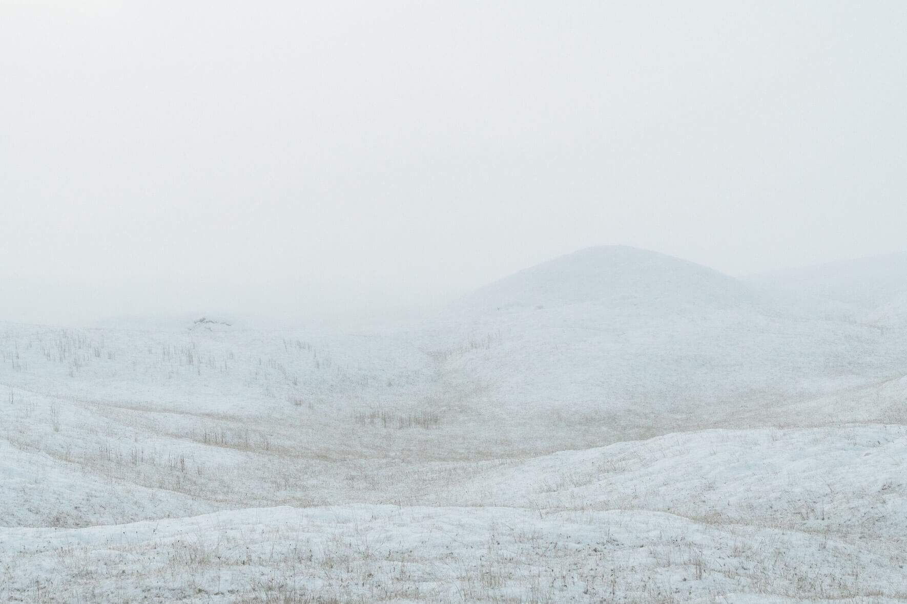 Minimalist scene with snow covered hills in winter