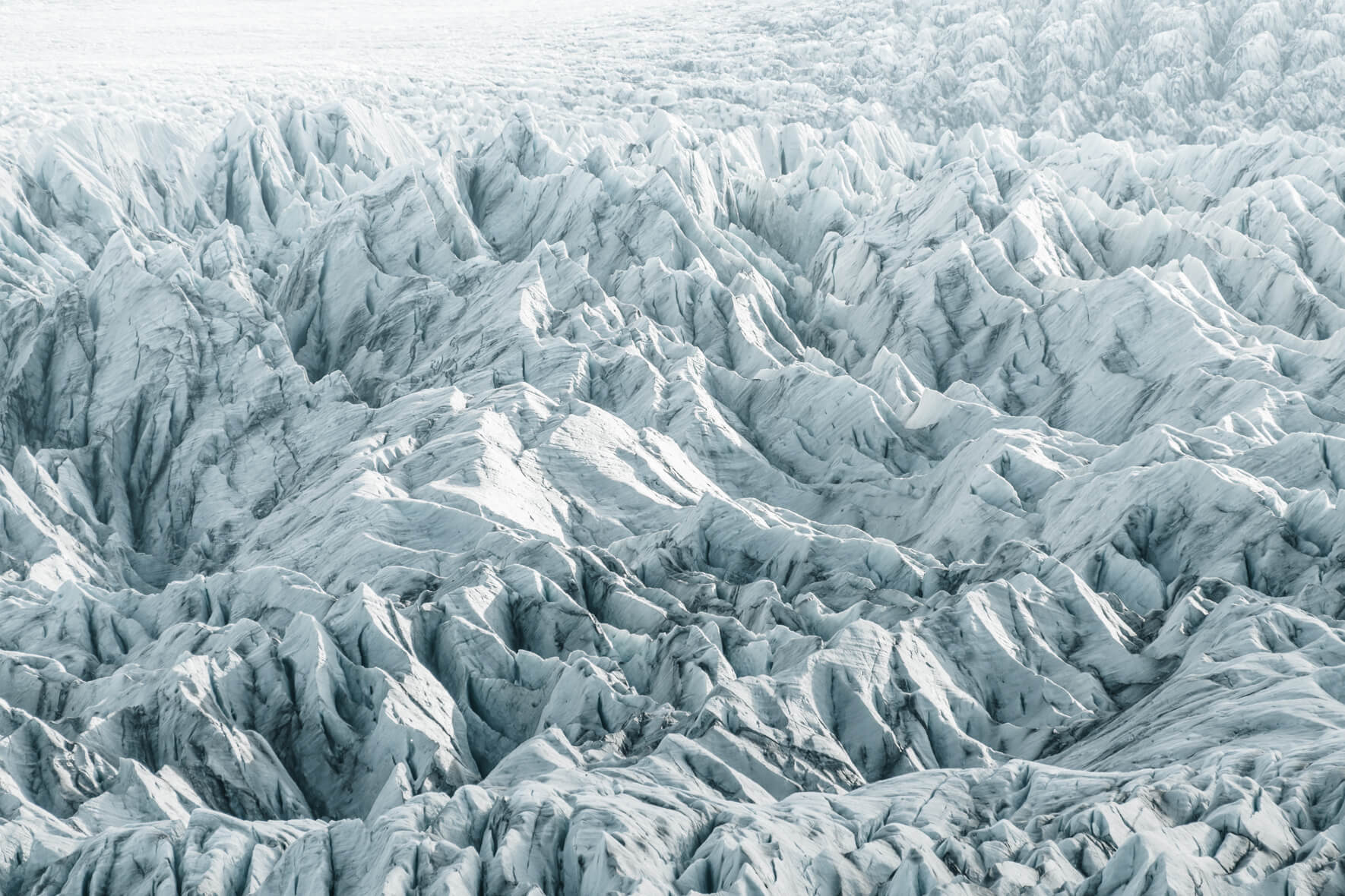 Fjallsárlón glacier in Iceland in bright sunlight and almost monochromatic colors
