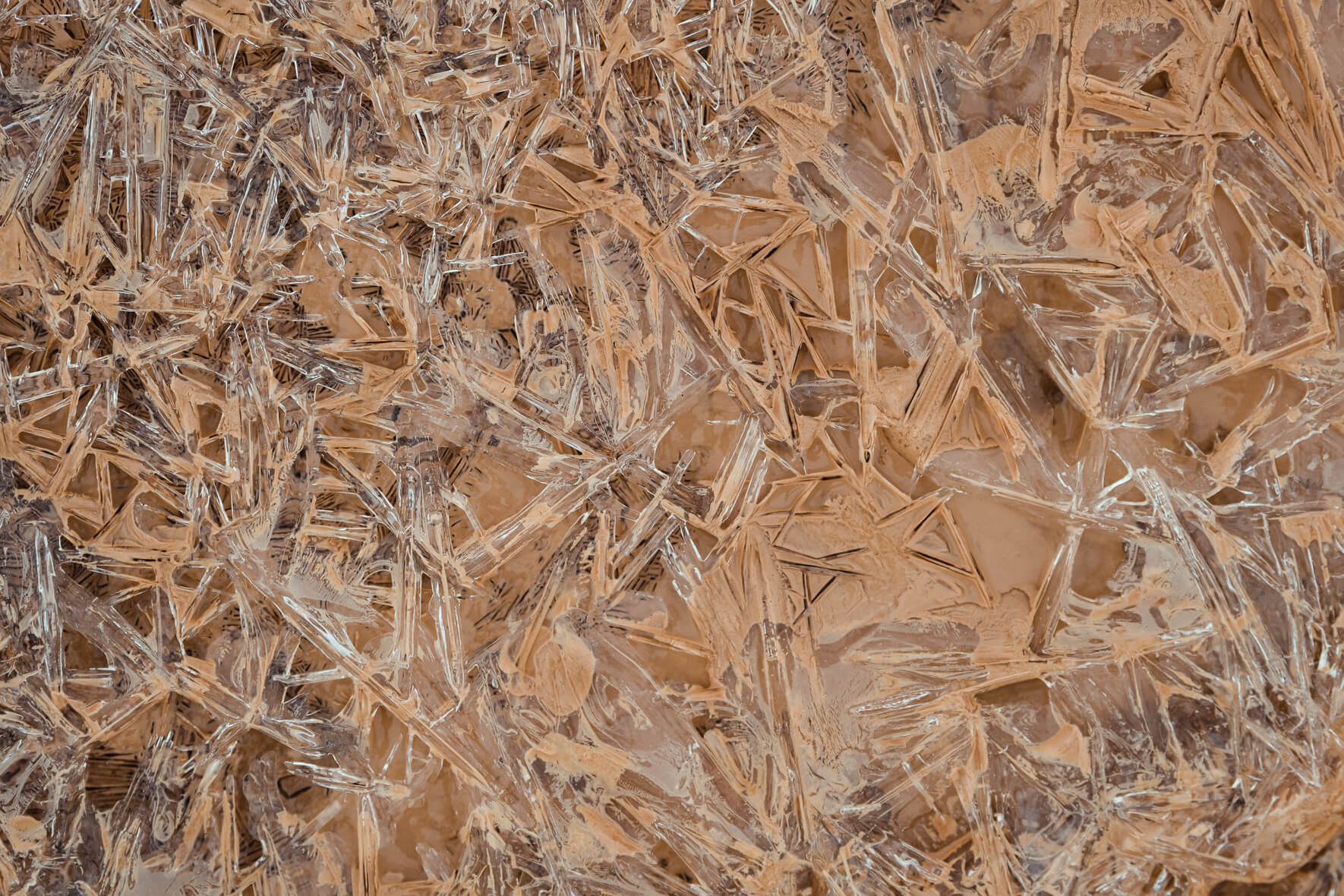 Macro photography of abstract ice crystals in a muddy creek