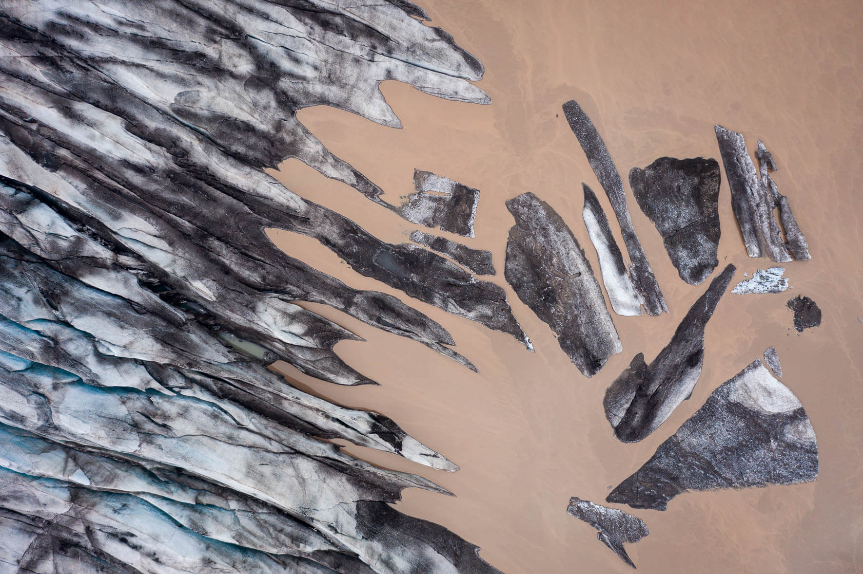 Aerial view of Fláajökull glacier in Iceland with glacial lake and single icebergs