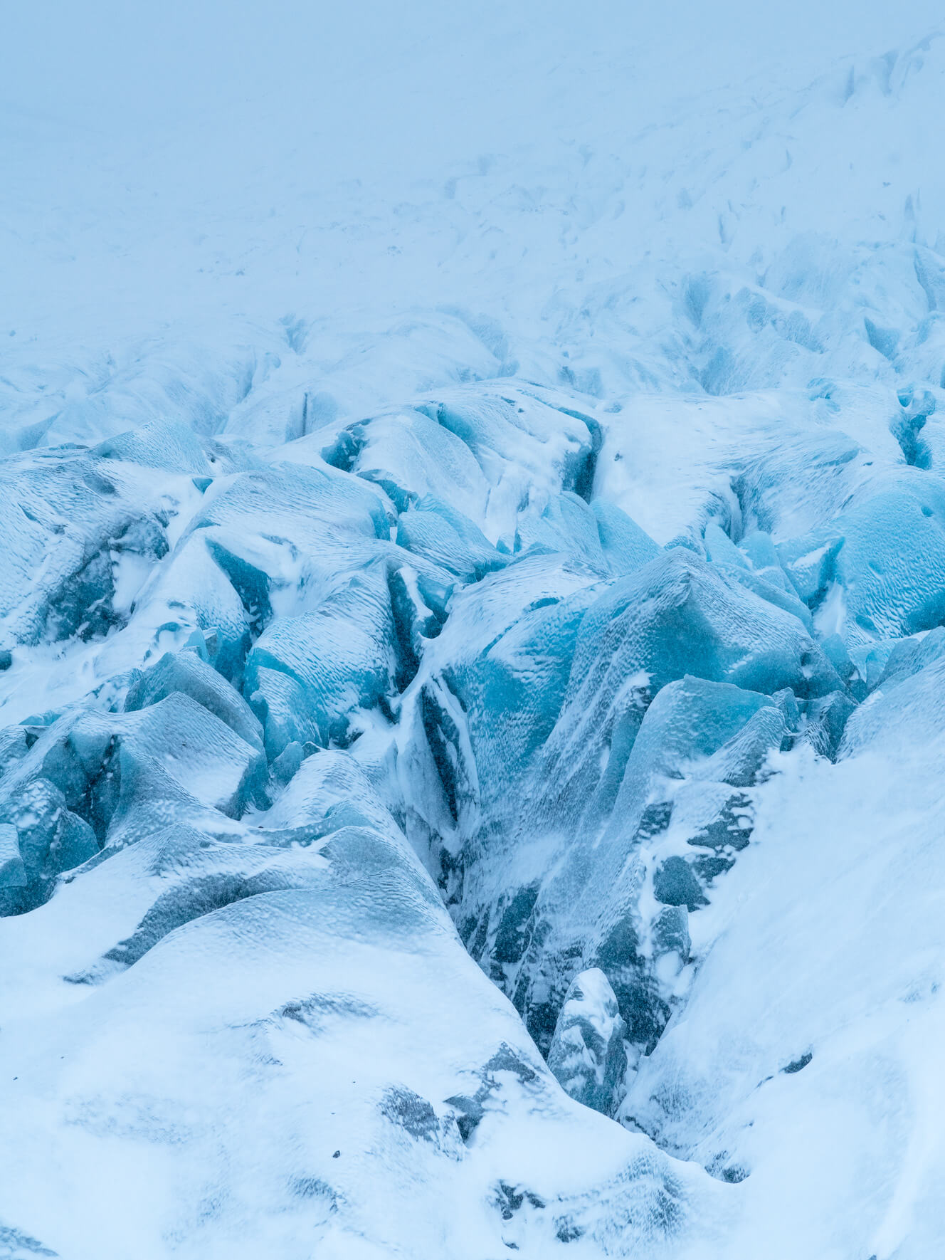 Deep crevasses in Svínafellsjökull glacier in Iceland after a heavy snow shower