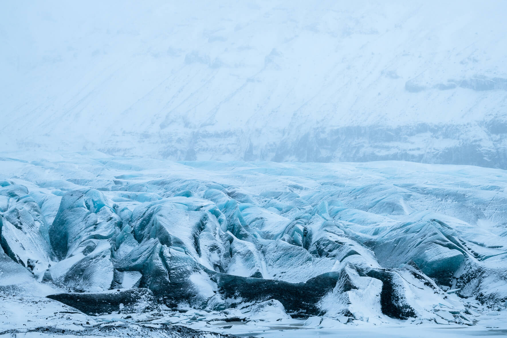 Svínafellsjökull glacier during winter with snow clouds over the ice