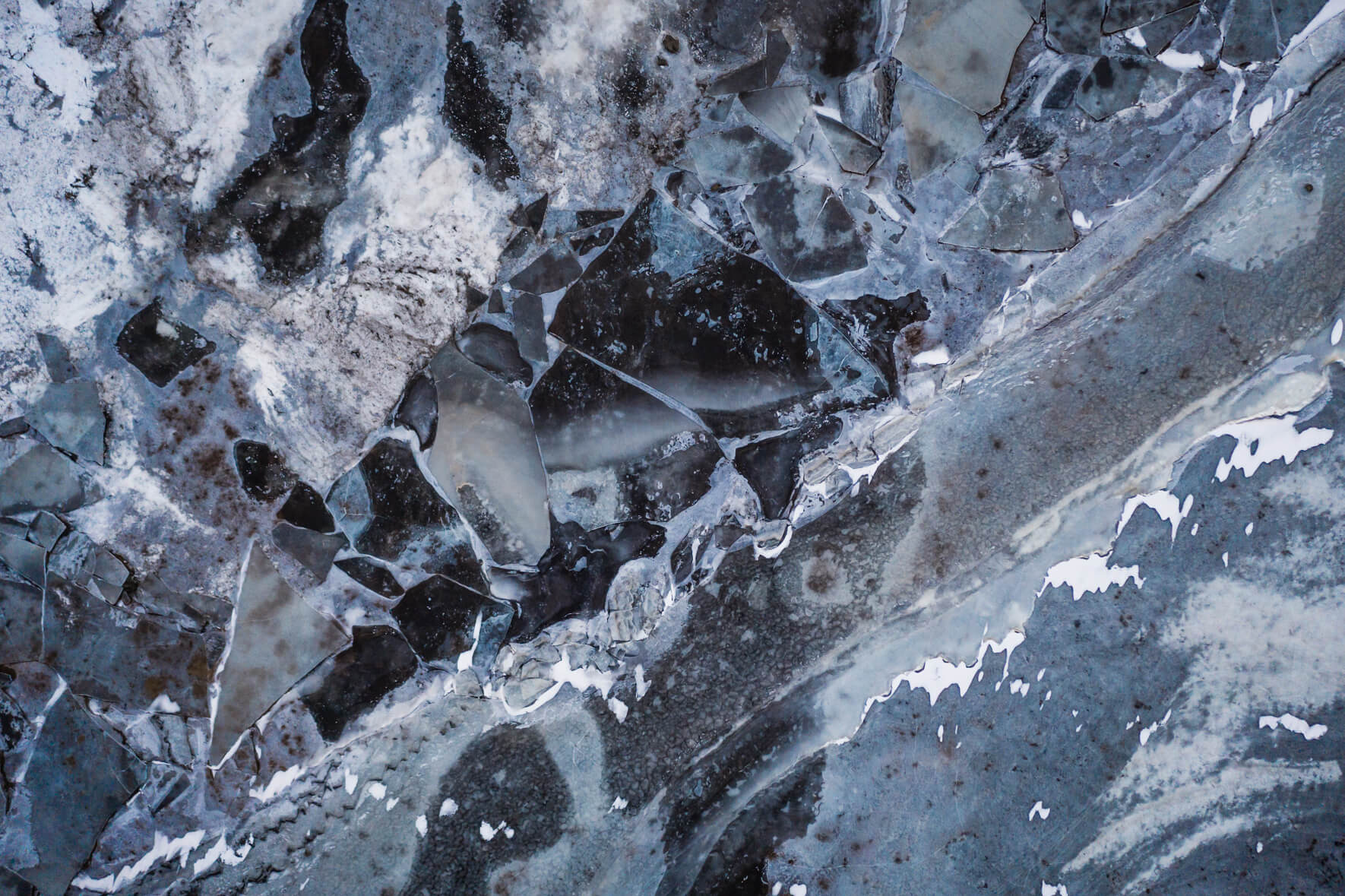 Abstract and colorful puzzle of ice floes on the frozen river Ölfusá