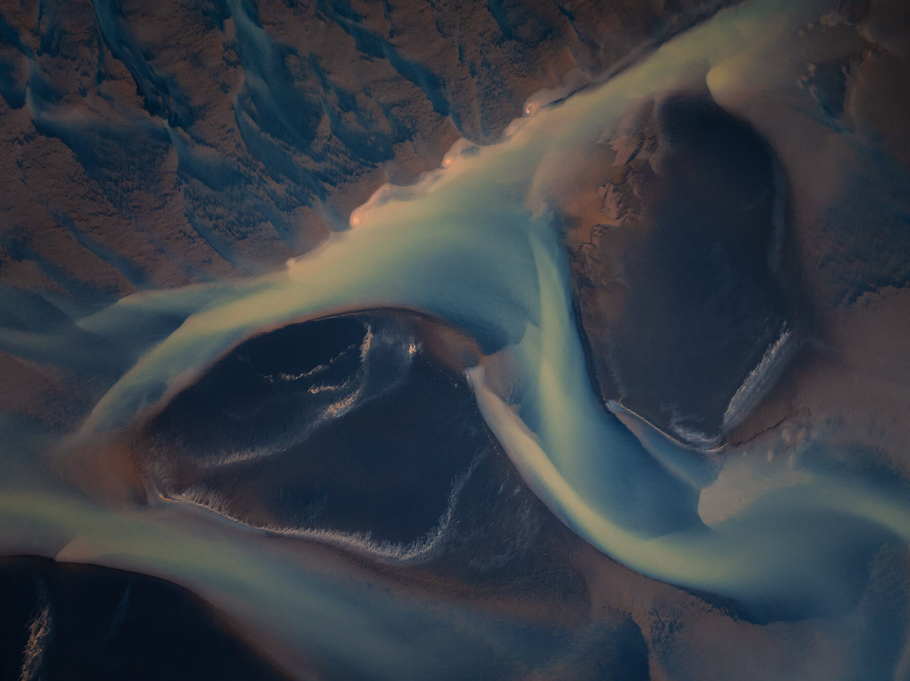 Drone shot of Iceland’s glacial meltwater rivers flowing toward the coastline