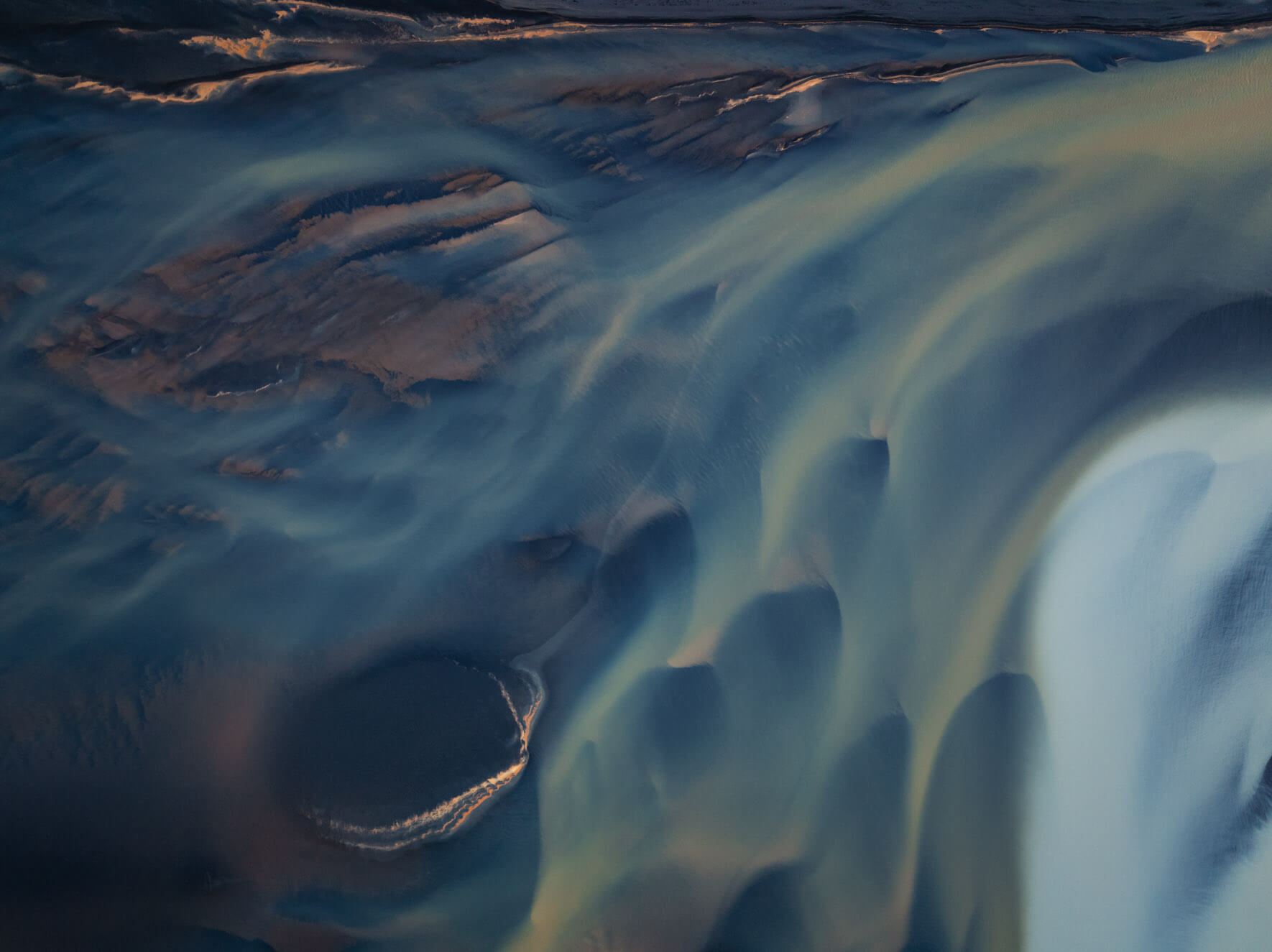 Sediment-laden currents of the Þjórsá River creating otherworldly patterns from above