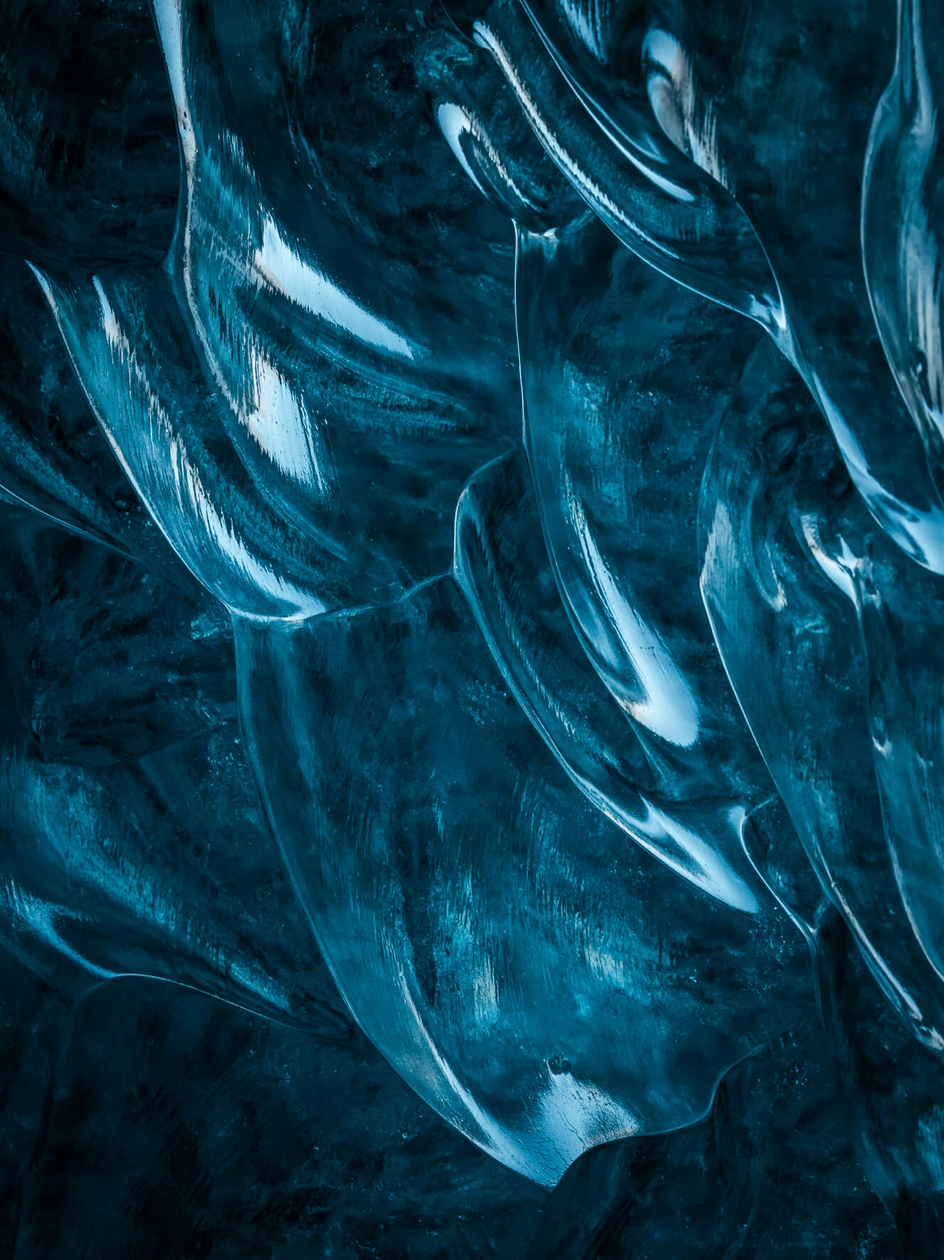 Reflections on glacial ice in an ice cave in Iceland