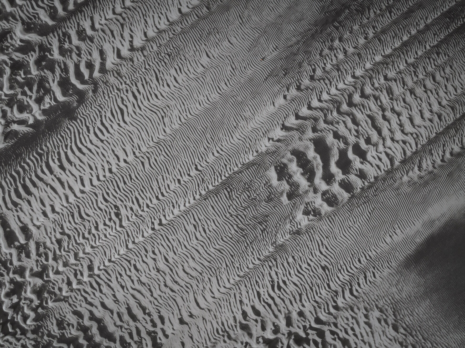 Aerial shot of Iceland’s low tide sand formations resembling natural glitch art