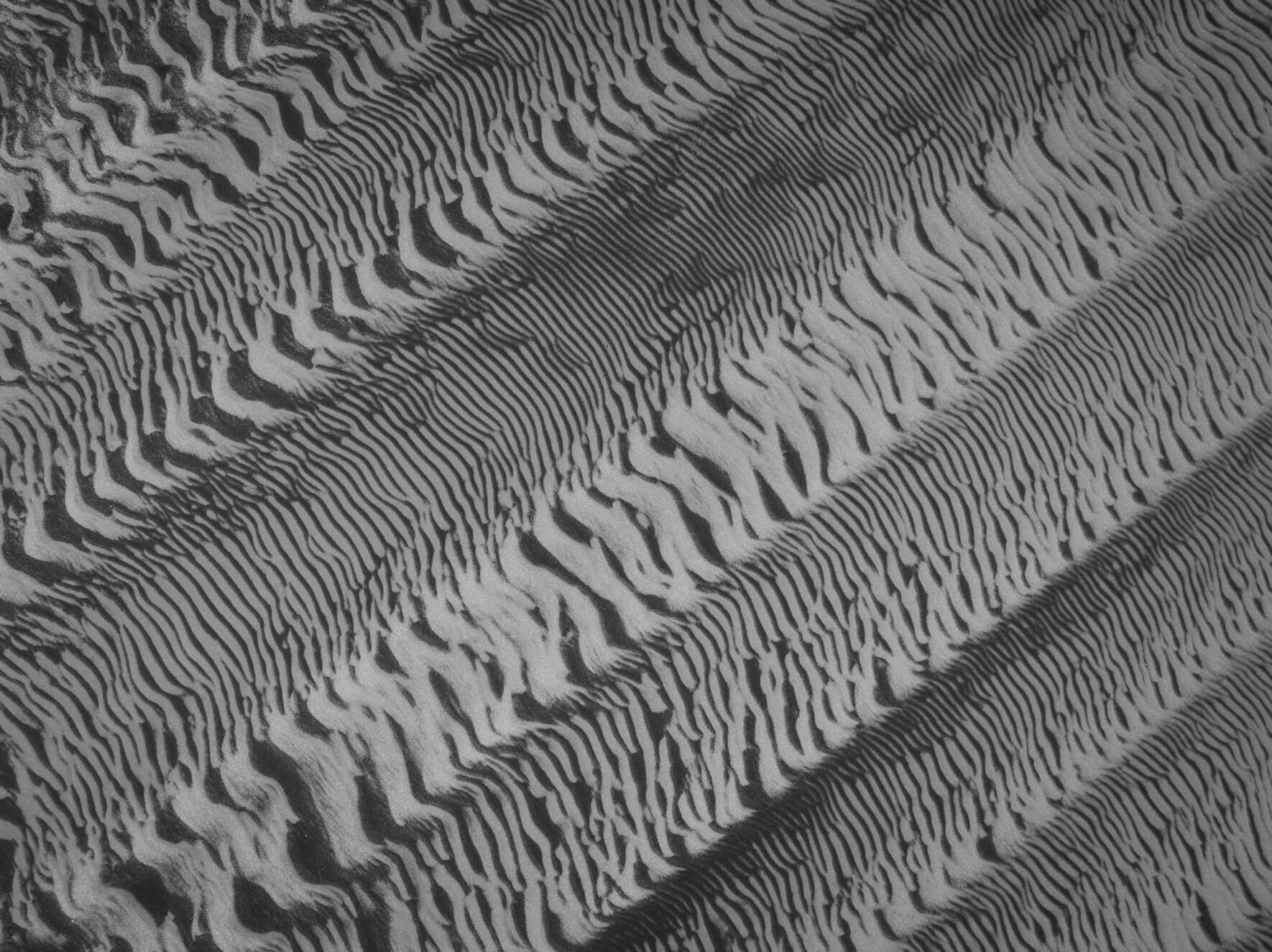 Abstract aerial shot of Iceland’s low tide sand formations resembling natural glitch art