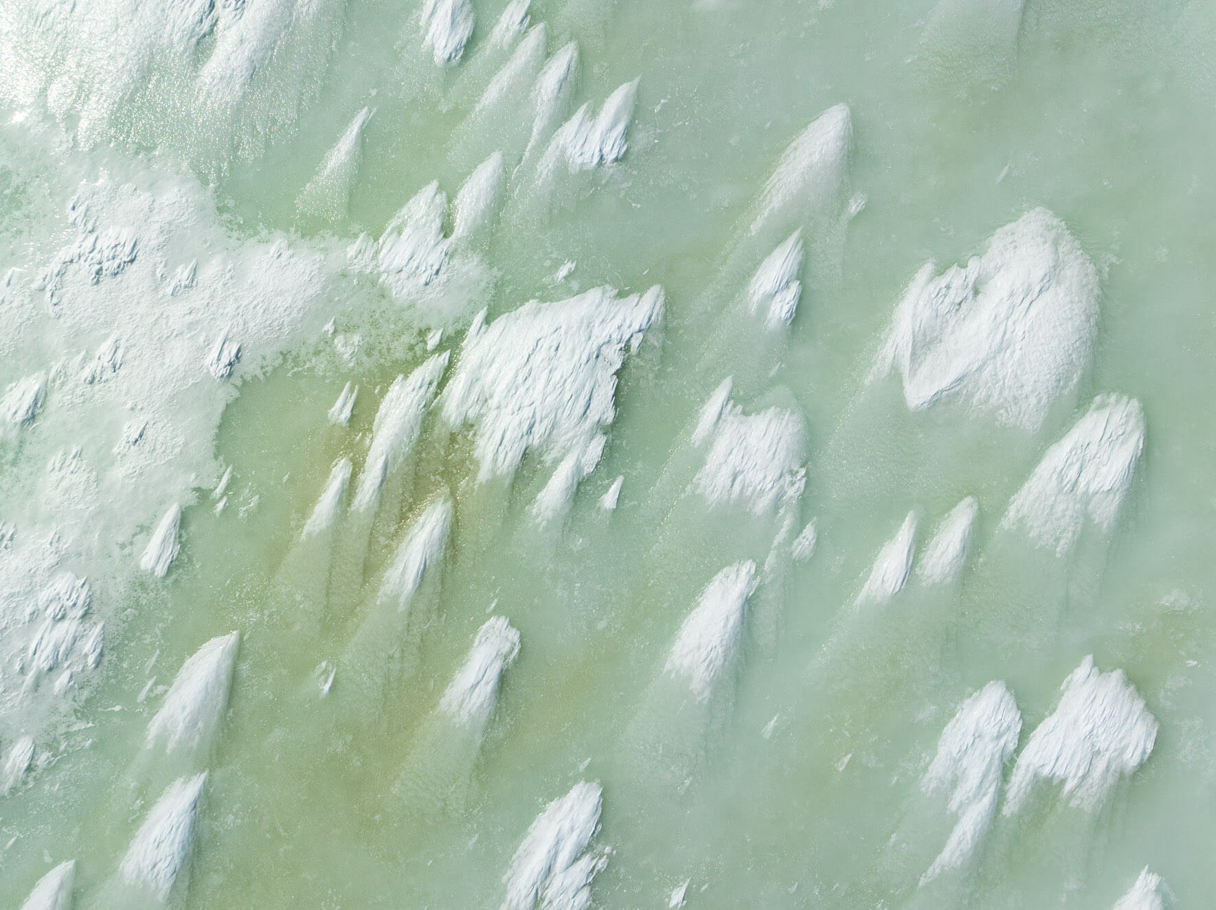 Aerial close-up of frozen lake textures in Hardangervidda Norway shaped by wind and ice