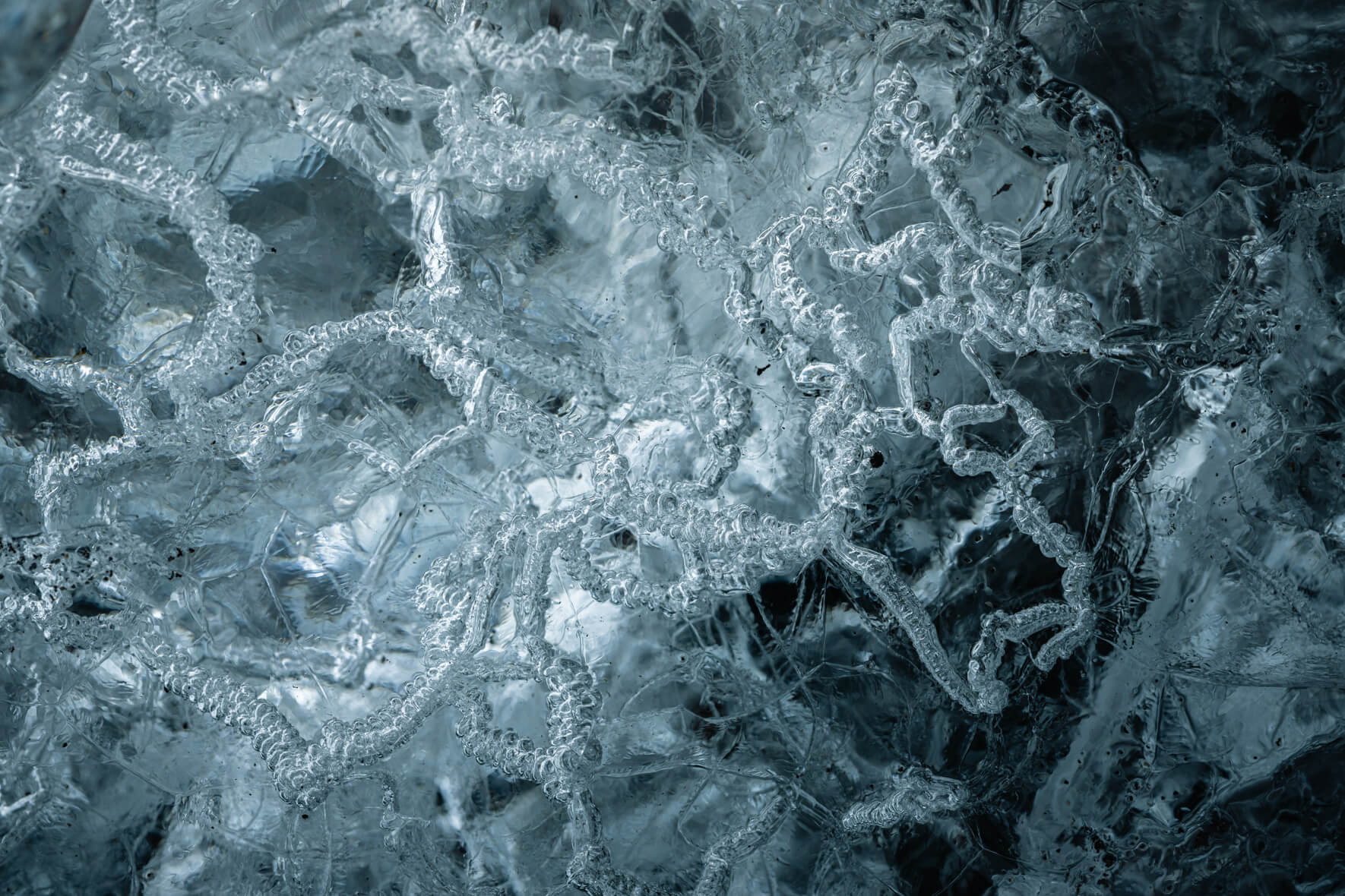 Macro of translucent ice showing trapped air bubbles and smooth crystalline layers