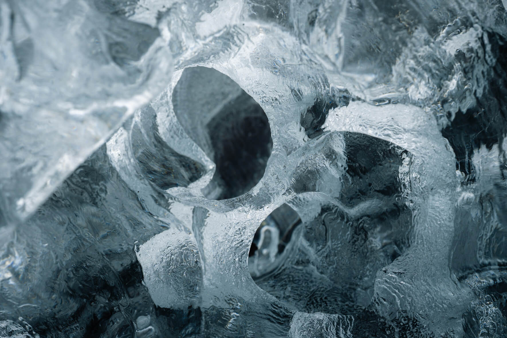 Complex details of melting iceberg on black volcanic sand in Iceland