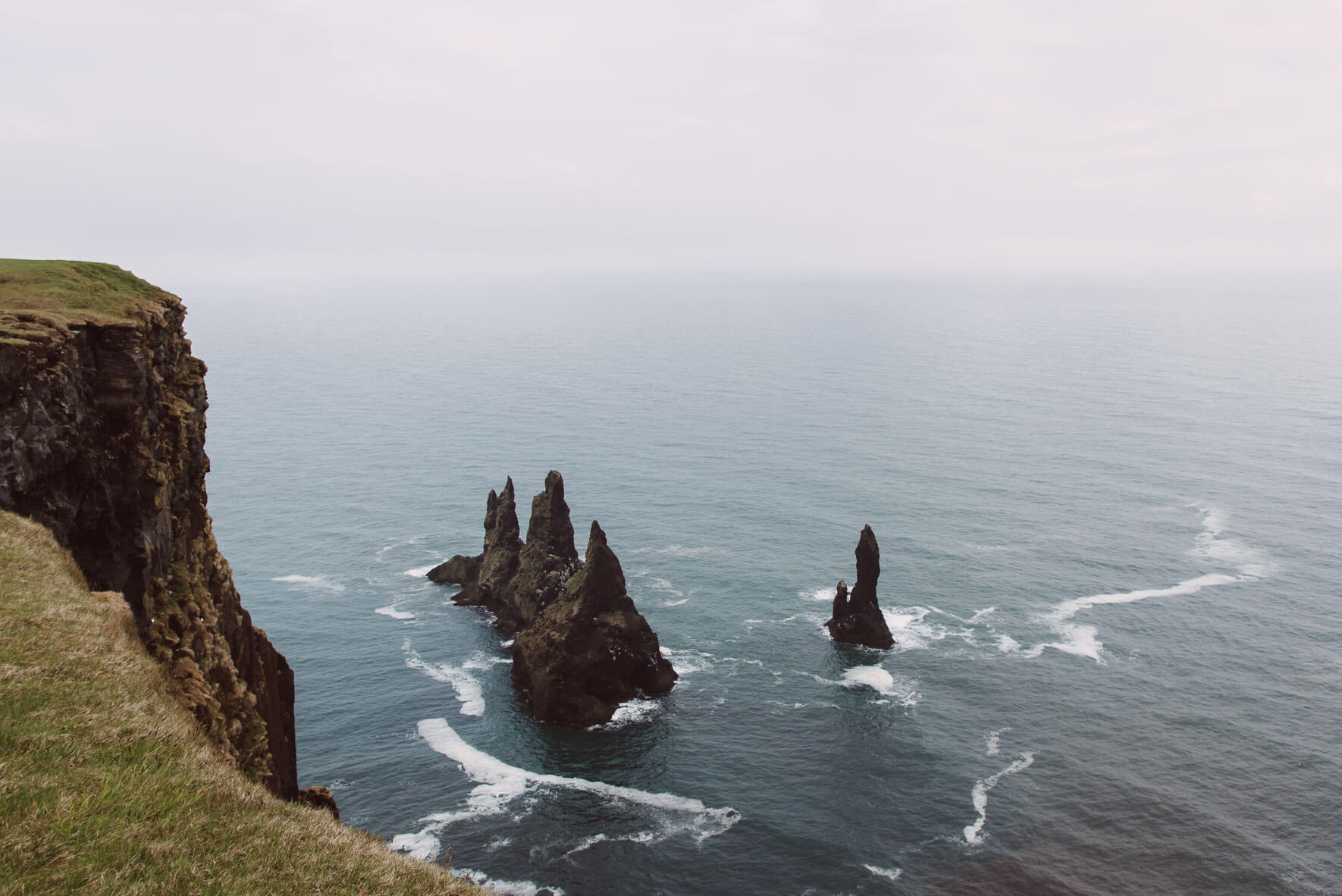 Reynisdrangar basalt sea stacks under the mountain Reynisfjall in Iceland