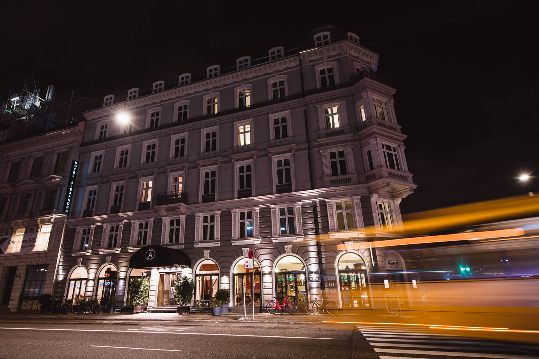Hotel Alexandra in Copenhagen at night with moving bus