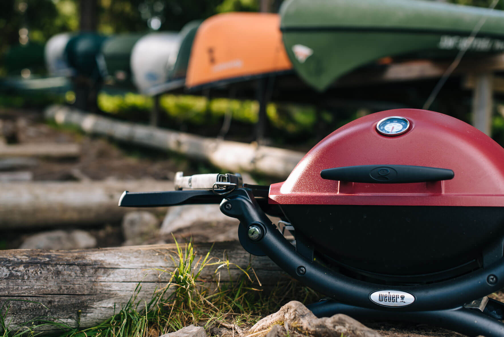 Weber Q1200 grill in Norway with colorful canoes