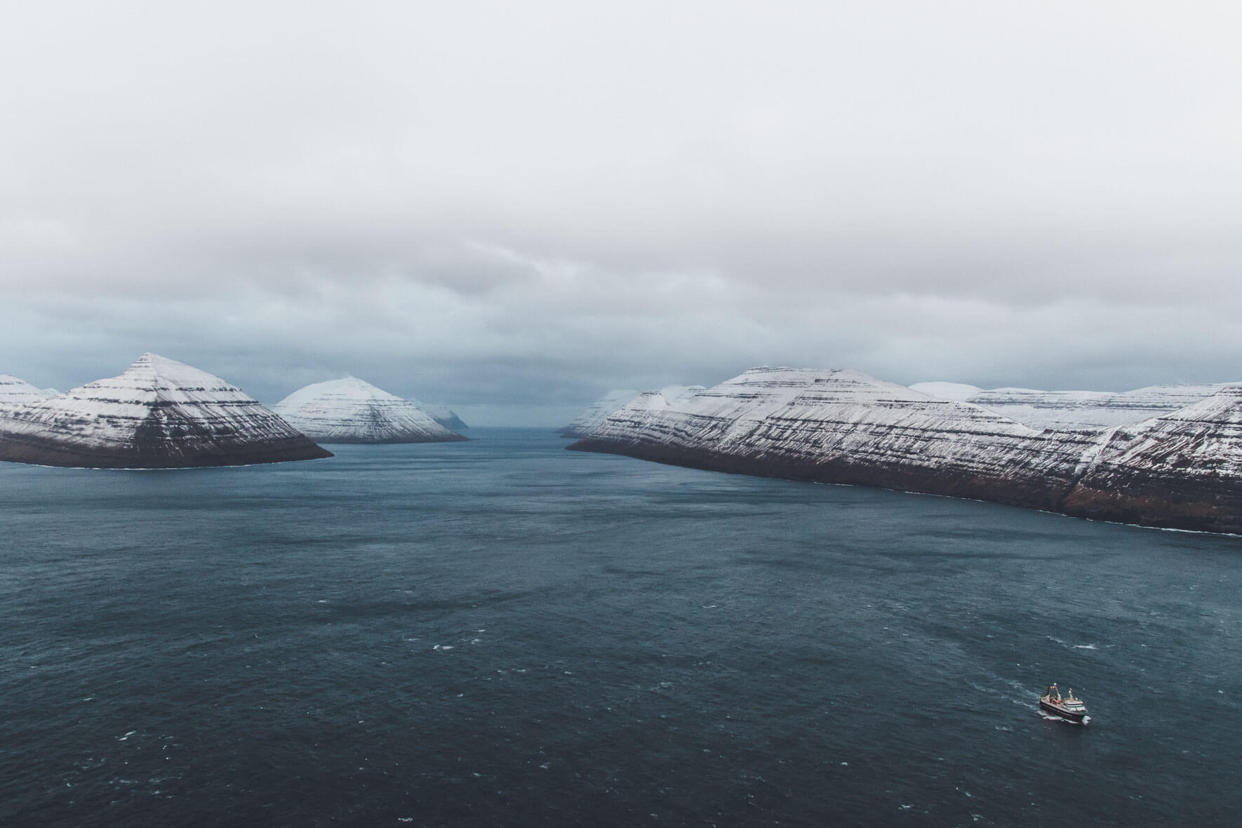 Aerial view of the Faroe Islands with fishing vessel in Winter