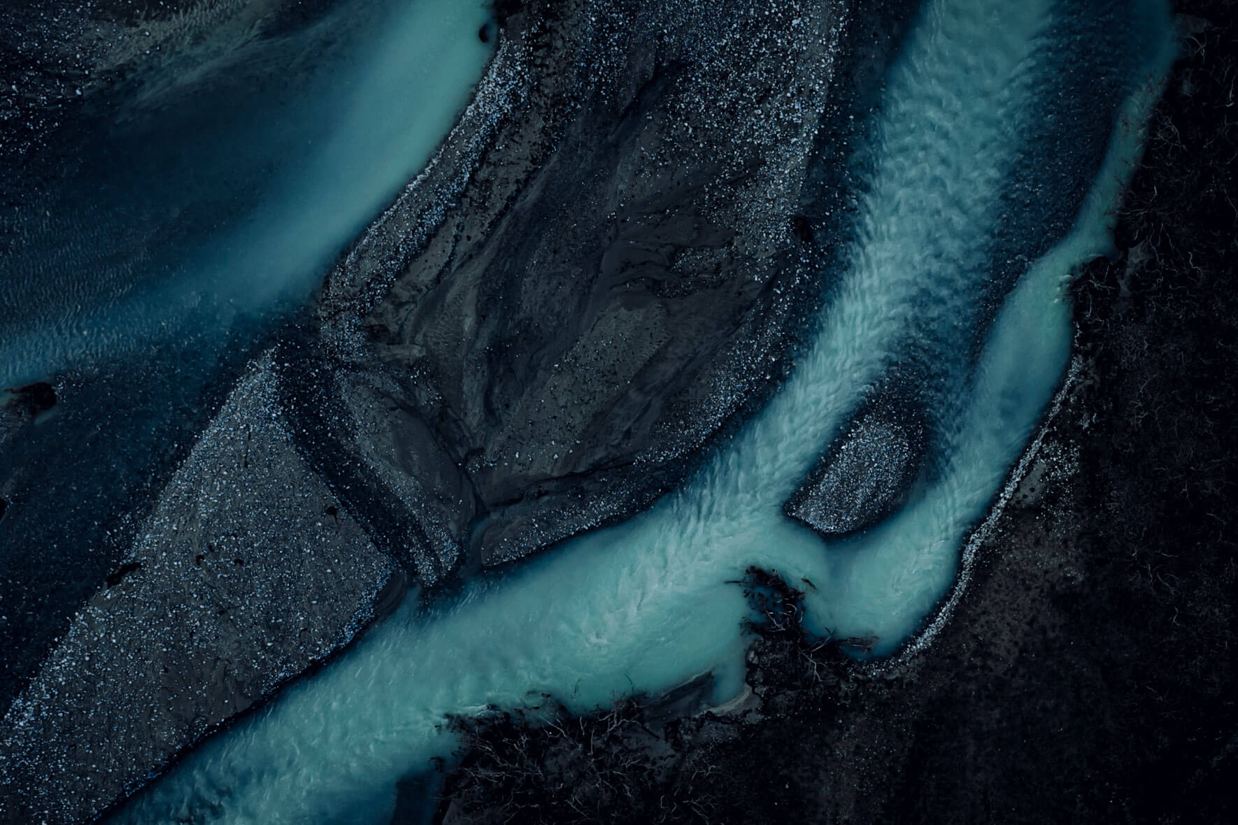Dark blue glacial meltwater rivers from above (DJI Mavic 2 Pro)
