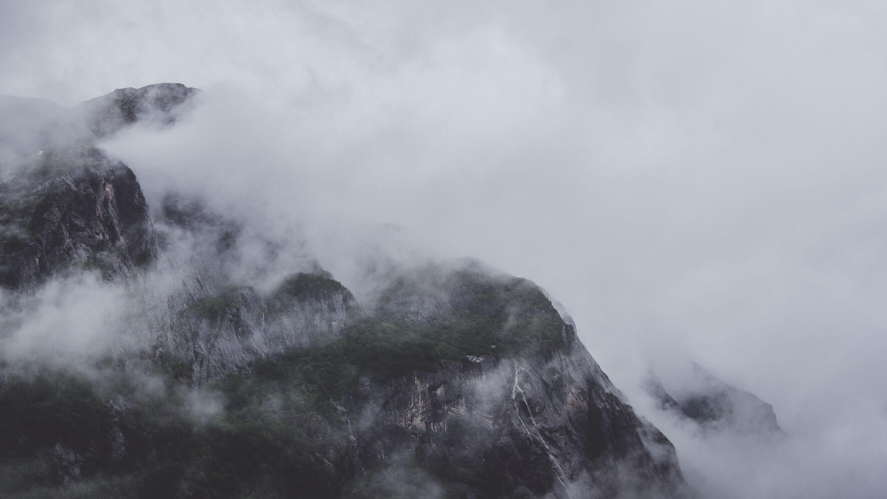 Mountains and clouds near the fjord Eidfjorden in Norway
